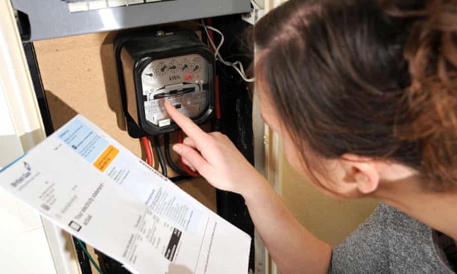 Woman reading electricity meter.