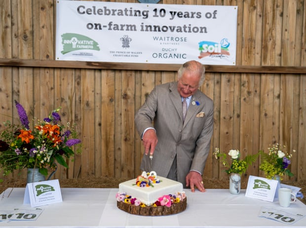 The then Prince Charles cuts a celebratory cake with members of the Innovative Farmer network at a Duchy Organic pop-up café in Launceston in July.