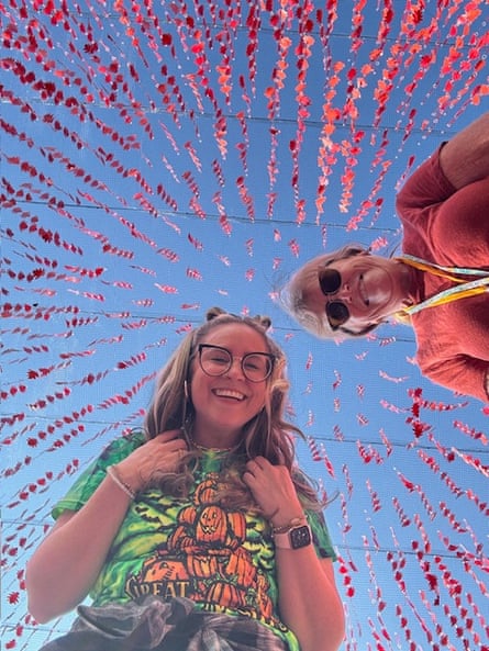 Two women smiling with red streamers surrounding them