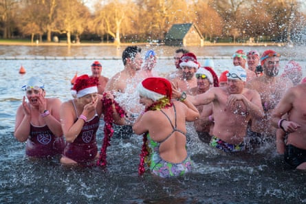 Christmas swimmers splash around in a lake