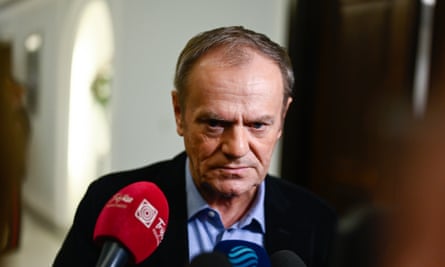 Donald Tusk looking concerned, with a microphone visible being held out towards him