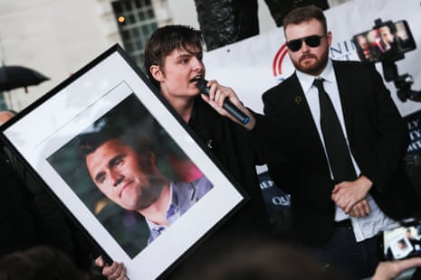 A man holds a picture of Charlie Kirk while speaking next to Jack Ross, Chief Operations Officer for Turning Point UK, during a vigil at the Montgomery Statue in Whitehall, to commemorate U.S. conservative activist Charlie Kirk, who was fatally shot while speaking at an event at Utah Valley University, in London, Britain, September 12, 2025.