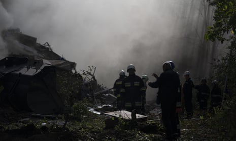 Firefighters work at the scene where a residential building was heavily damaged after a Russian attack in Zaporizhzhia, Ukraine, Sunday, Oct. 9, 2022. (AP Photo/Leo Correa)