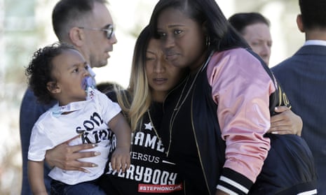 Salena Manni, center, the fiancee of police shooting victim Stephon Clark, holds the couple’s son, Aiden as she is hugged by Cecilia McClenton at a rally calling for police reform on Saturday.