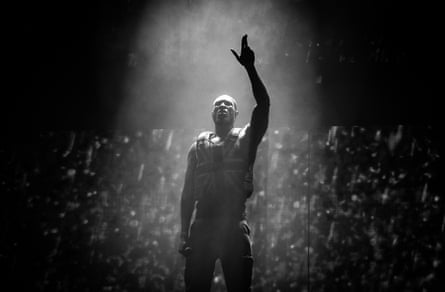 Black and white photo of Stormzy, in union jack stab vest, on the Pyramid Stage at Glastonbury Festival, UK, June 28 2019