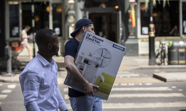 A man carries a fan in London