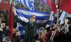 A Syriza supporter waves the Greek flag