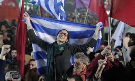 A Syriza supporter waves the Greek flag