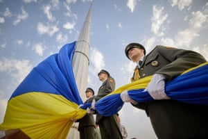 Members of the Honour Guard watch a Ukrainian flag being raised