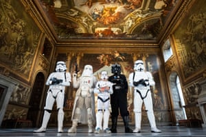 Fans dressed as Star Wars characters stand in a room with 17th-century frescoes on the walls ceiling