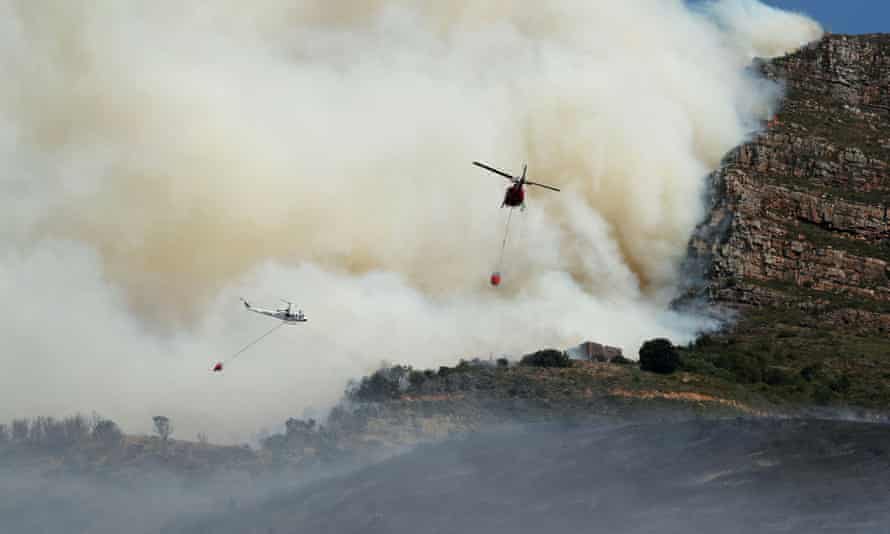 Helicopters battle a bushfire that broke out on the slopes of Table Mountain in Cape Town