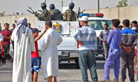 Iraqi security forces arrive to disperse a demonstration outside oilfields near Basra on 17 July.
