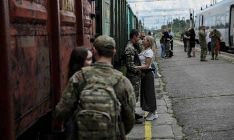 Couples bid each other farewell at the railway station in Kramatorsk, Donetsk region.