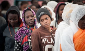 Migrants queue up after arriving by boat in Salerno, Italy.