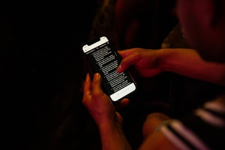 A person scrolls through a guide on their phone