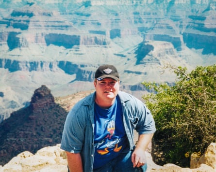 A young man poses at a canyon view point
