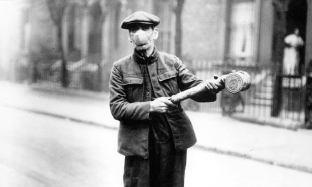 A man in a protective face mask with an anti flu spray, March 1920.