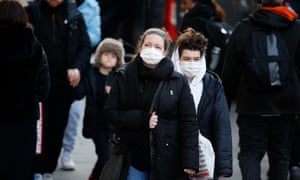 Shoppers wearing face masks as protection against   coronavirus walk along Regent Street in London.