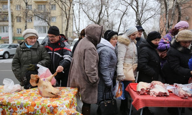 A queue to buy fresh raw meat from private vendors at a monthly street market in Kemerovo, Russia. State statistics have revealed the number of people living below the poverty line is increasing.