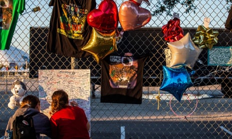 People attend a makeshift memorial at NRG Park, where eight people died in a crowd surge at the Astroworld festival.