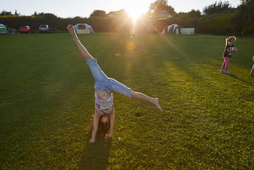 Emma Flanagan doing cartwheels while her parents cook a barbecue meal