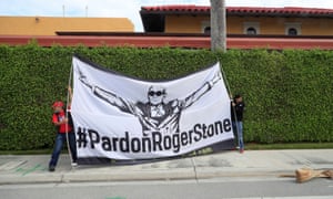 Demonstrators display a banner urging Donald Trump to pardon his former campaign adviser Roger Stone, as the presidential motorcade passes through West Palm Beach, Florida, in March.