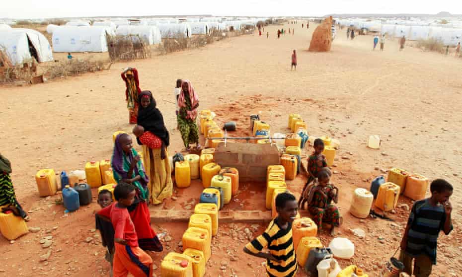 Somali refugees gather to collect water at the Kobe refugee camp, near the Ethiopia-Somalia border, during the 2011 famine