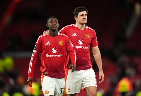 Manchester United's Kobbie Mainoo and Harry Maguire celebrate following the UEFA Europa League quarter-final, second leg match at Old Trafford on April 17, 2025.