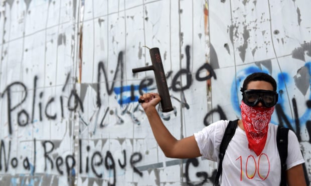 A masked young man holds a homemade mortar during  protests against the government of Nicaragua’s president, Daniel Ortega.