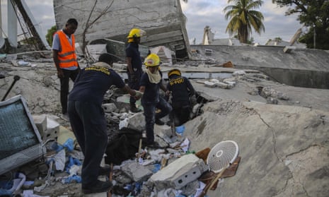 Firefighters search for survivors inside a collapsed building, after Saturday´s 7.2 magnitude earthquake in Les Cayes, Haiti.