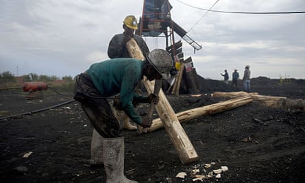 Miners make wooden support beams in a coal mine in Agujita, Coahuila state, on 13 November 2012.