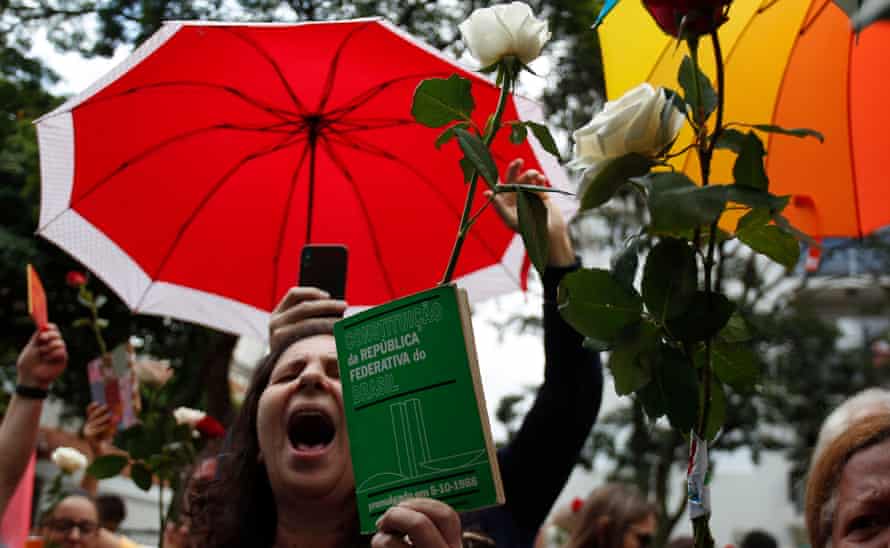 A supporter of Brazilian presidential candidate for the Workers Party (PT) Fernando Haddad, holds a Brazilian constitution as she shouts slogans, in Sao Paulo, Brazil during the second round of the presidential election, on October 28, 2018. - Brazilians will choose their president today during the second round of the national elections between the far-right firebrand Jair Bolsonaro and leftist Fernando Haddad (Photo by Miguel SCHINCARIOL / AFP) (Photo credit should read MIGUEL SCHINCARIOL/AFP/Getty Images)