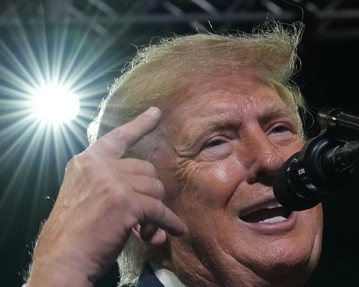 Trump targets Ilhan Omar at rally following raid on her home – US politics live