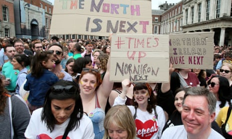 Campaigners in Dublin hold posters calling for Northern Ireland to liberalise its strict abortion laws