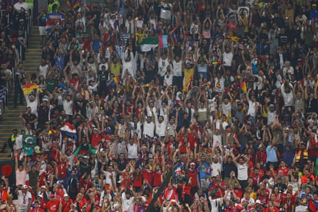 Fans do a Mexican wave during the first half of the game