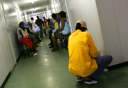 African people wait in a hospital corridor to be seen by doctors in Botswana.