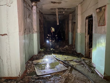 Emergency workers inspect the damage inside a building in Kharkiv.