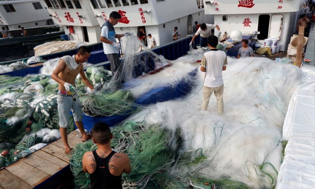 Fishermen arrange nets at the Qingkou port in east China’s Jiangsu province.