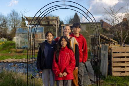 Emma Rabbitt with her children Patrick, Lydia and Seren standing under an arch on their allotment