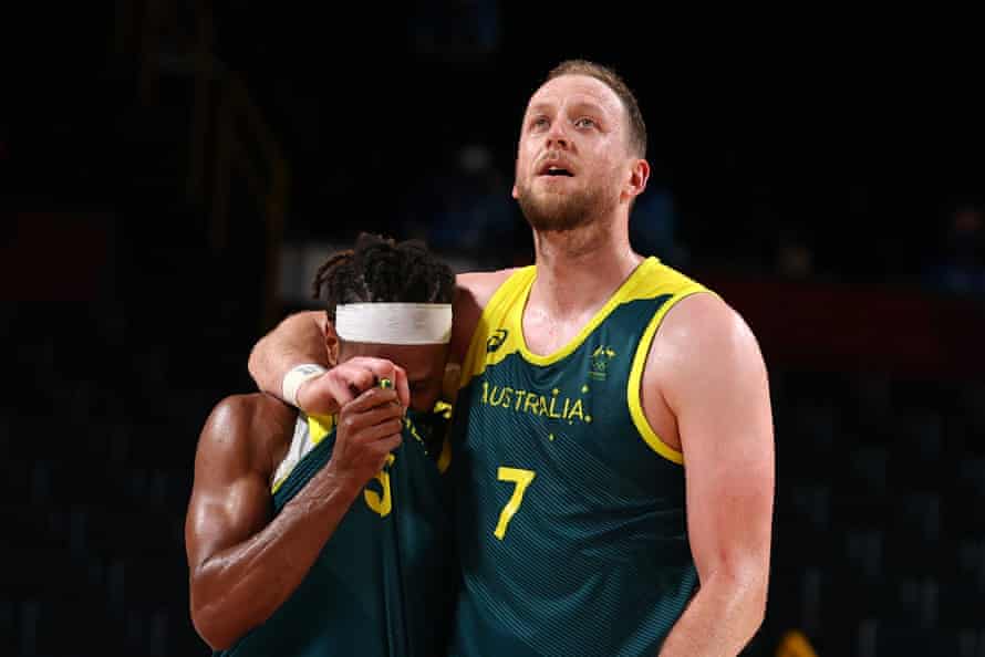 Patty Mills is hugged by teammate Joe Ingles after winning the bronze medal match against Slovenia in Japan.