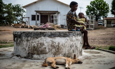 Bendu Alliou sits with her infant daughter outside the hospital in Kailahun, eastern Sierra Leone, 2016. In the wake of the Ebola epidemic, and recovering from a long civil war, Sierra Leone is now confronted with the highest maternal mortality rate in the world with a staggering 3100 maternal deaths per year.