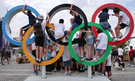 Children play at a display of Olympic rings