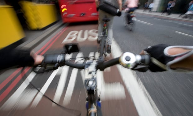 Cycling in traffic in London.