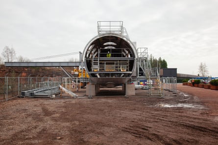 A cylindrical building under construction with scaffolding around it