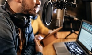 Man recording a podcast, speaking into microphone
