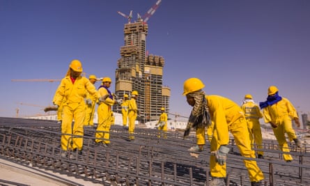 South Asian immigrant contract laborers from Bangladesh, India, and Pakistan work at a construction site in Dubai.