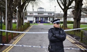 A police officer at the entrance to Ashton playing fields where a 16 year old boy was stabbed to death, in Woodford Bridge Essex.
