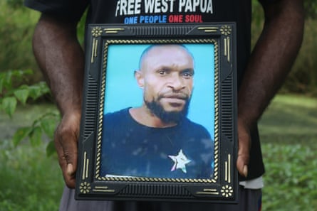 Charles Sraun holding photo of Kristian Yandun in Merauke, West Papua.