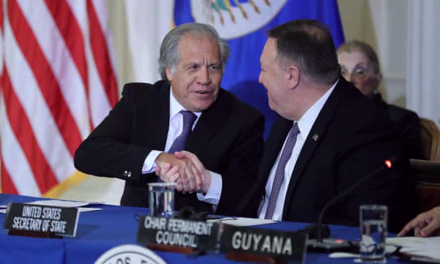 The former US secretary of state Mike Pompeo, right, and the Organization of American States secretary general, Luis Almagro, at an OAS meeting last year, shaking hands
