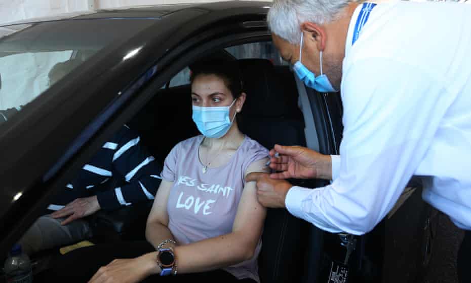 woman in car getting vaccinated